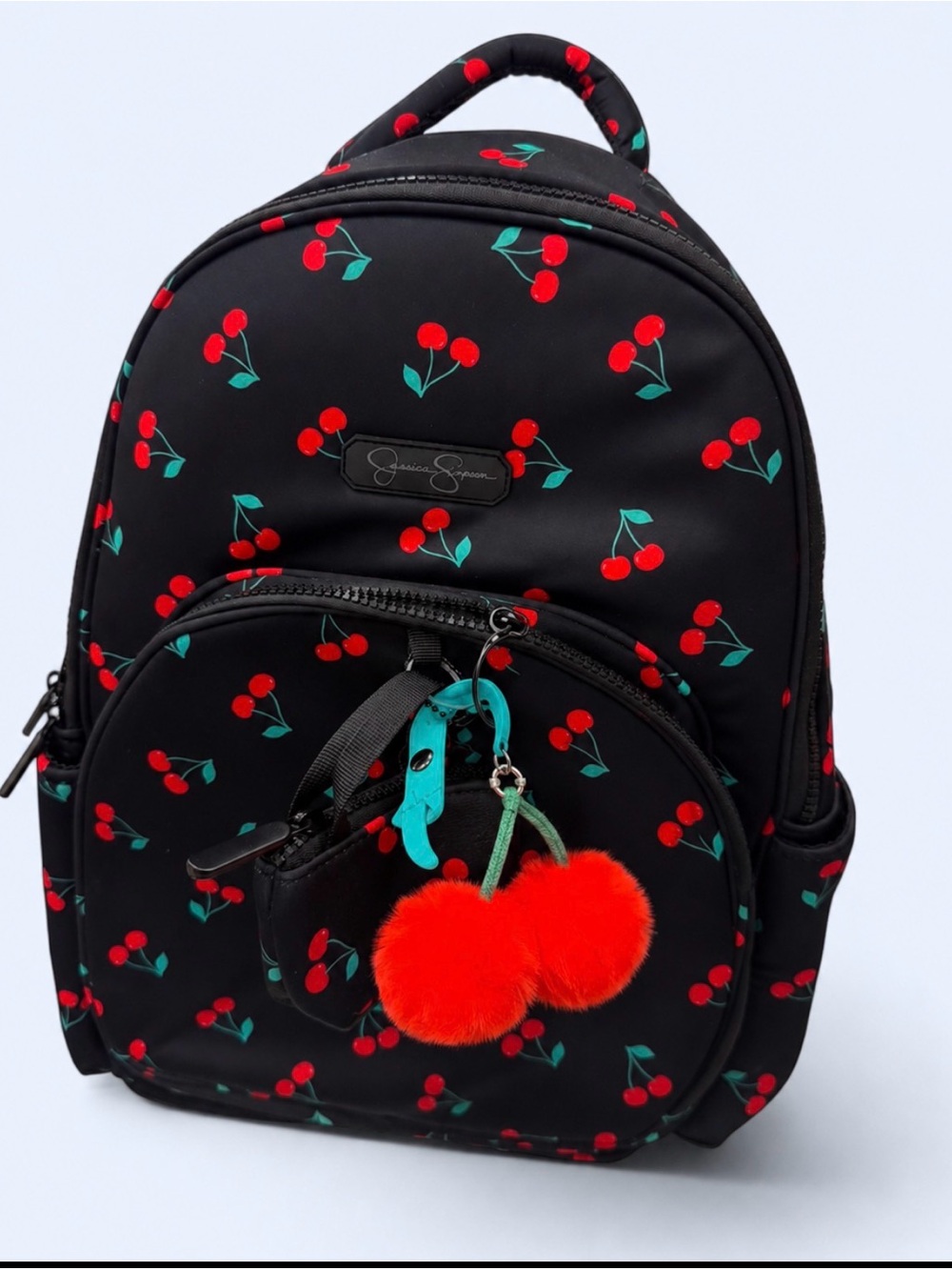 Jessica Simpson Black Backpack with Red Cherry Print and Red Pom-Pom Charm